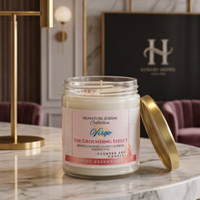 A scented candle in a clear glass jar with a white wax fill and a pink-and-white label, shown on a marble countertop with its gold lid leaning beside it. The candle is branded Signature Zodiac Collection and named 'Virgo'.