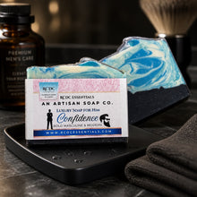 Artisan soap with packaging labeled 'RCDC Essentials' on a dark surface.