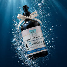 Bottle of shower gel and body wash with a decorative bow, submerged underwater with sunlight filtering through.