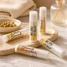 RCDC Essentials Chamomile lip balm tubes on a marble surface with a neutral background
