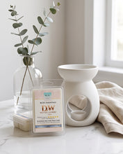 A packaged wax melt card labeled 'D.W.