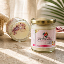 Paradise Island scented candle with decorative lid on a wooden surface