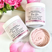 Two containers of RDC Essentials Neck & Decollete Cream with a swatch of cream on a white background.