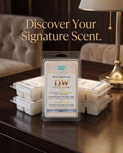 A packaged scented melting wax tart from RSCG Essentials DW Hotel Lobby is displayed on a dark wooden table, with stacks of similar packages around it and a softly blurred hotel lobby background with a lamp and sofa. Large text at the top reads, 'Discover Your Signature Scent.