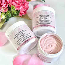Skincare cream jars with pink rose petals and flowers on a light background
