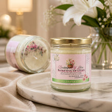 Scented candle jar labeled 'Basketful of Lilies' on a marble surface with flowers in the background.