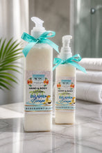 Two bottles of RDC Essentials Island Cottage hand and body lotion on a marble surface with a blurred background.