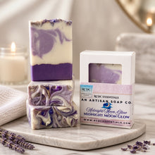 Three layered soap with a packaging box labeled 'RCDC Essentials' on a marble surface with lavender flowers.