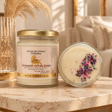 A jar candle labeled 'Signature Zodiac Collection Lee Summer Never Ends' stands on a marble surface next to an open jar showing creamy wax and multicolor confetti. The scene is styled in a warm indoor setting with a vase and dried grass in the background.