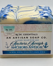A bar of RCDC Essentials 'Anchors Aweigh' luxury soap for him, featuring a cream and blue marbled pattern on the top, with a white paper label wrapped around the front.