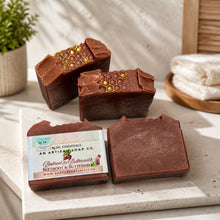 A bar of RCDC Essentials Beetroot & Buttermilk soap in a terracotta brown color, shown with its white paper label packaging in the foreground and a larger, faded duplicate of the same bar in the background.
