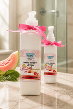 Two bottles of RCDC Essentials hand and body lotion with pink ribbons on a marble surface.