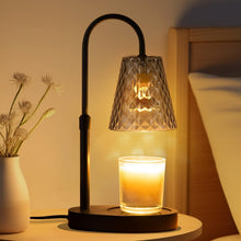 Decorative candle warming lamp with a glass shade and candle on a bedside table.