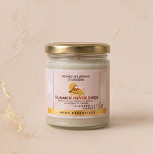 A single scented soy candle in a clear glass jar with a gold metal lid, set against a textured beige background with subtle gold leaf accents. The label reads 'Signature Zodiac Collection' and 'Summer Never Ends' by 'Leoch' and 'RCDC Essentials'.