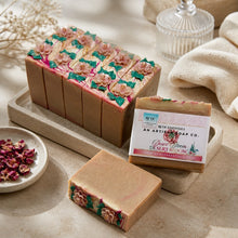 Decorative soap bars with floral designs on a stone tray, accompanied by a soap bar and its packaging.