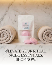 A white stand-up pouch labeled 'Crystaline' with pink bath salts, styled on a marble surface with rolled towels on both sides and text at the bottom reading 'ELEVATE YOUR RITUAL. KCDC ESSENTIALS.