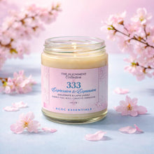 Candle in a glass jar with a pink label surrounded by cherry blossoms on a light blue background