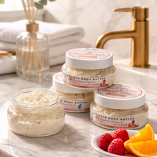 Jars of body butter on a marble countertop with fruits and a mirror in the background