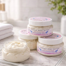 Jars of Souffle Body Butter with 'Enchanted Spell' label on a marble surface.